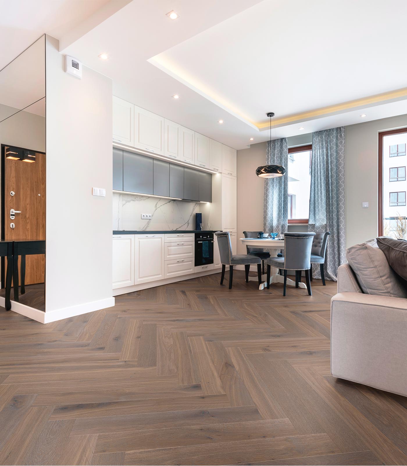 Herringbone Biarritz warm grey wide plank hardwood — room view
